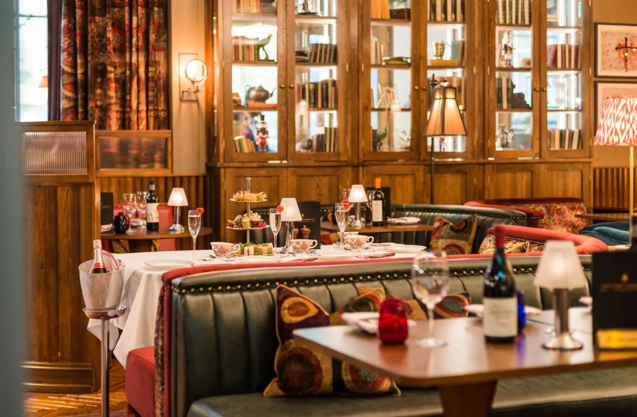 a restaurant with a table with wine glasses on it at King Street Townhouse Hotel & Spa in Manchester