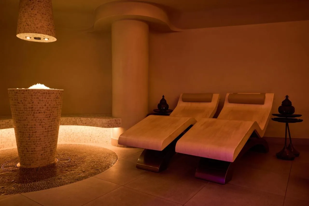 a waiting room with a bench and a table at King Street Townhouse Hotel & Spa in Manchester